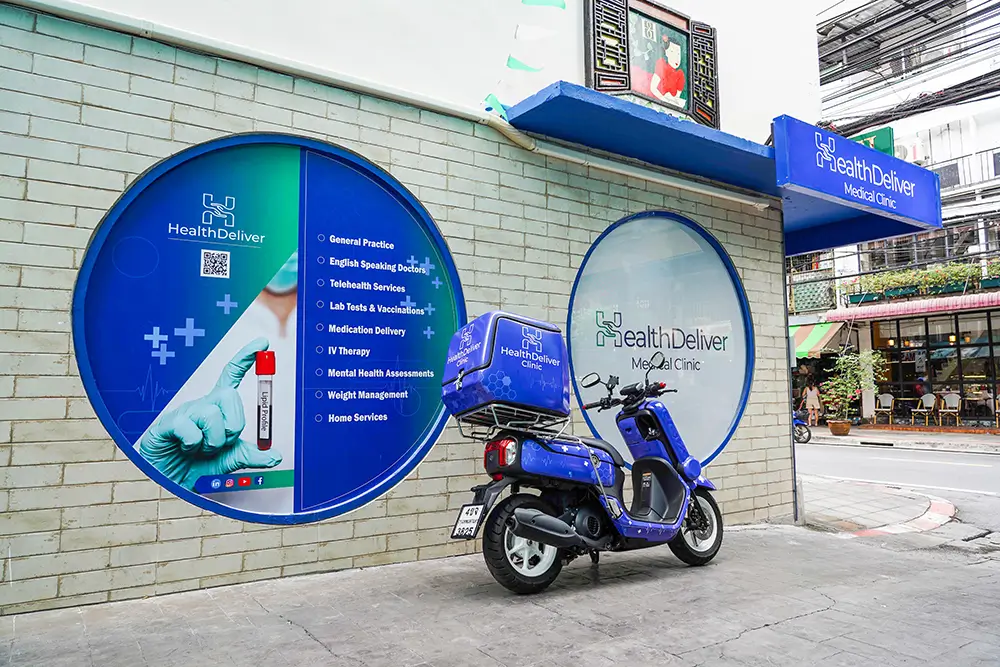HealthDeliver Medical Clinic storefront with blue scooter and circular signage