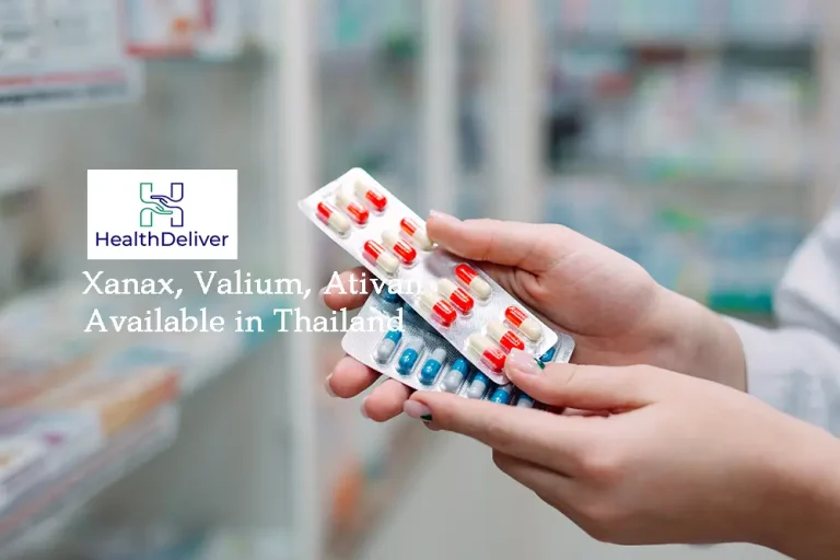 Pharmacist holding a box of prescription medicine in a Bangkok pharmacy