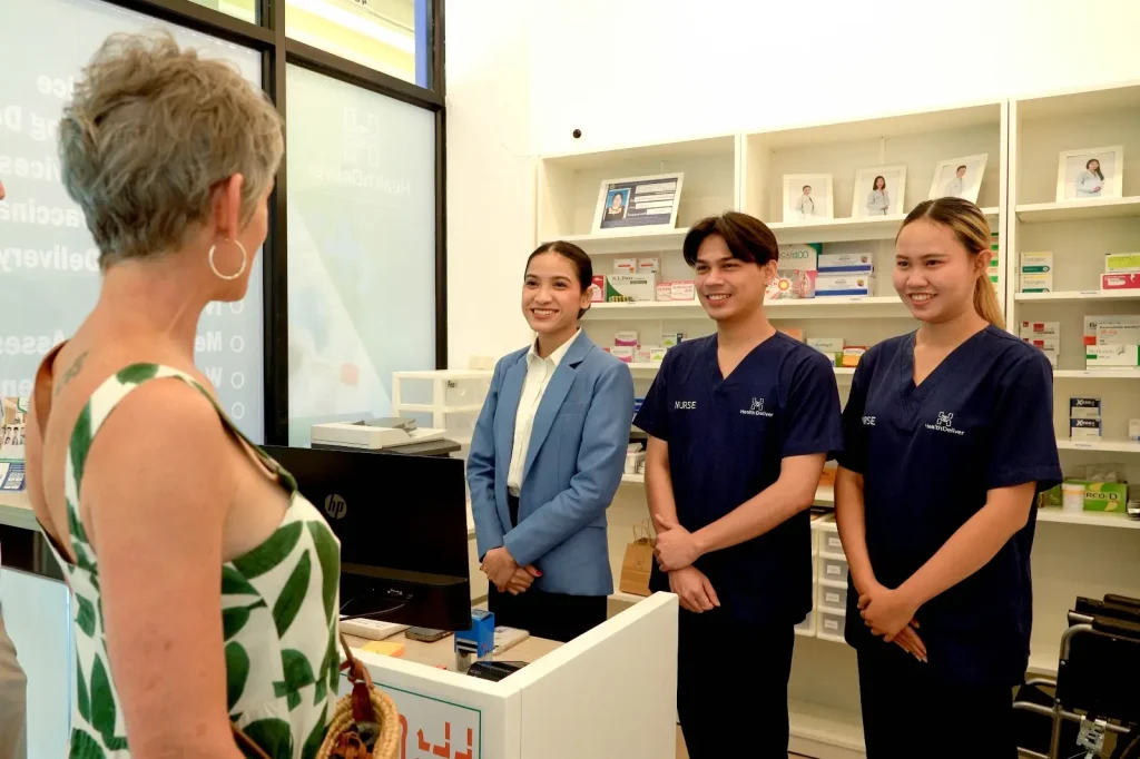 Healthcare professionals and staff discussing HPV vaccination in medical clinic pharmacy