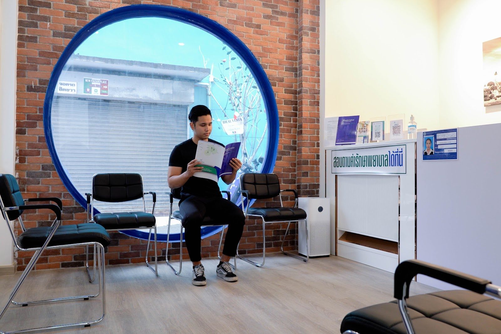 Waiting area with round window at HealthDeliver Clinic Sathorn